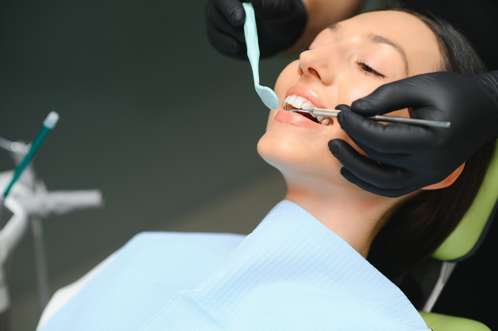 Dentist examining a patient's teeth in the dentist