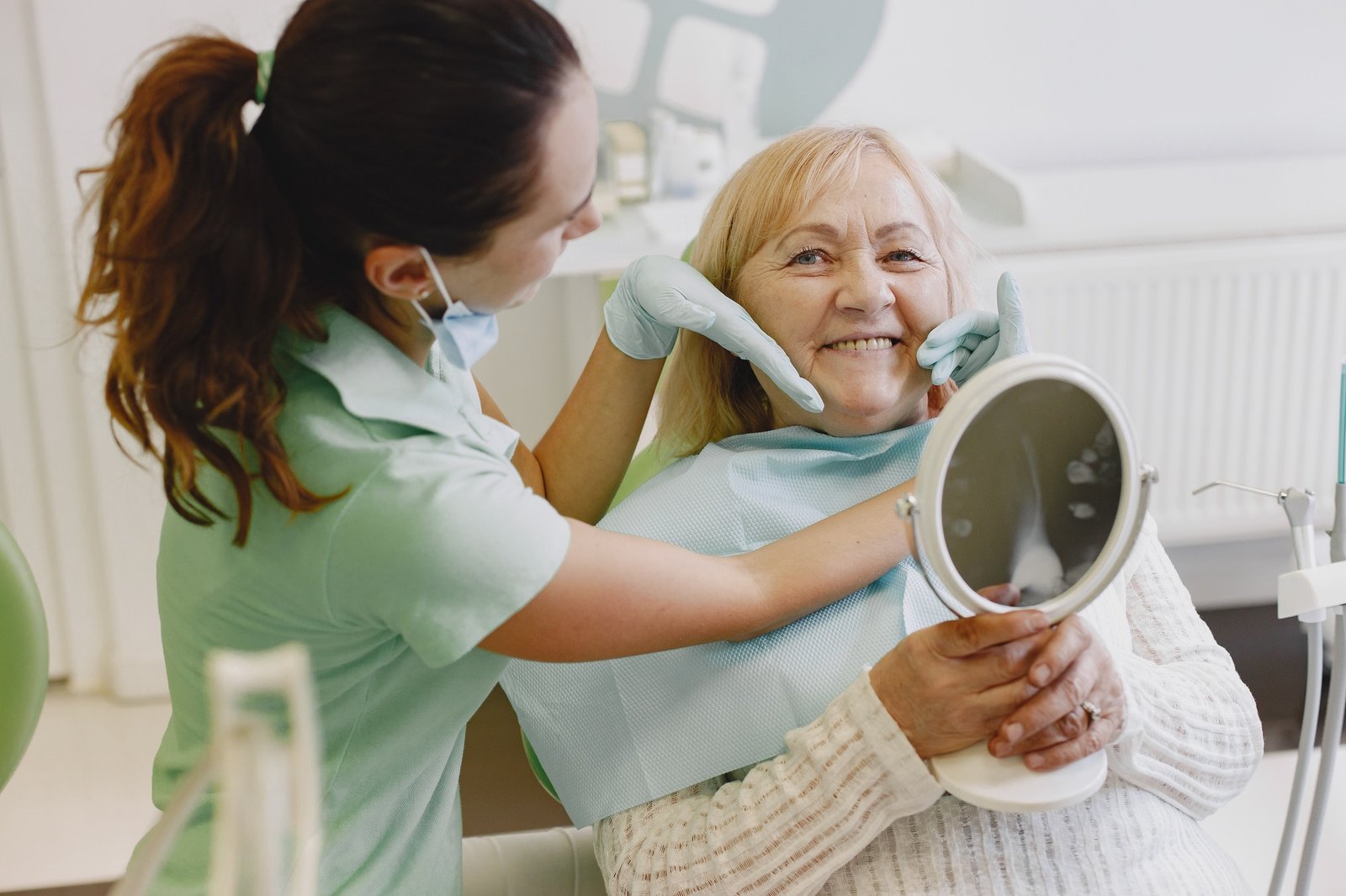 Dentist looking her old patient with tools
