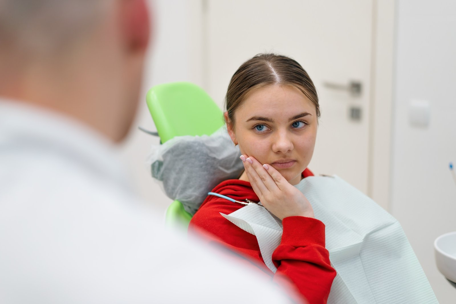 upset patient at the dentist's appointment complains toothache and caries dental office