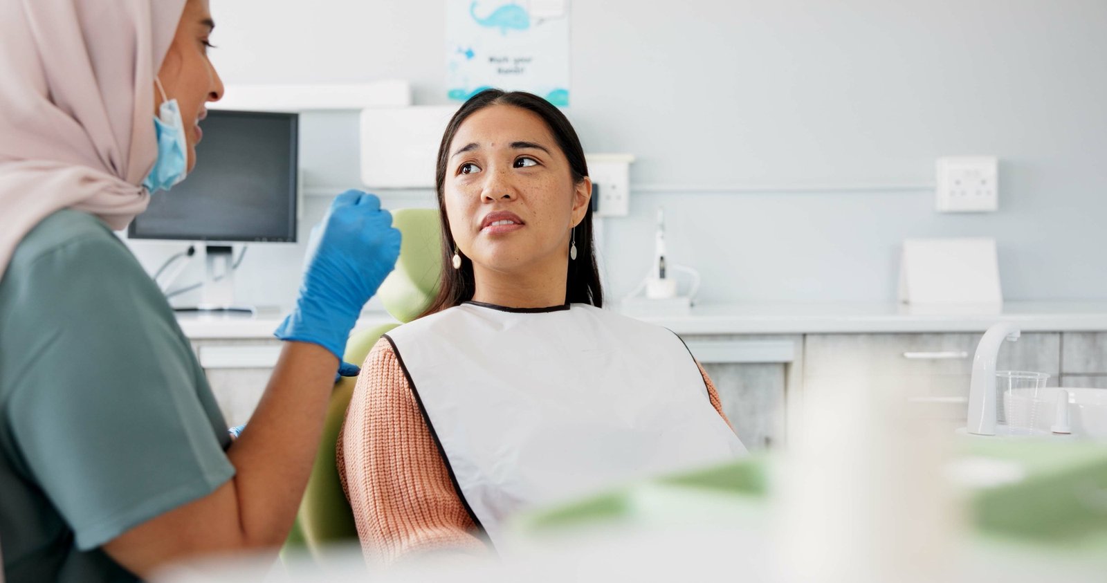 Woman, dentist and consulting with patient for dental care, teeth cleaning or treatment at the clin